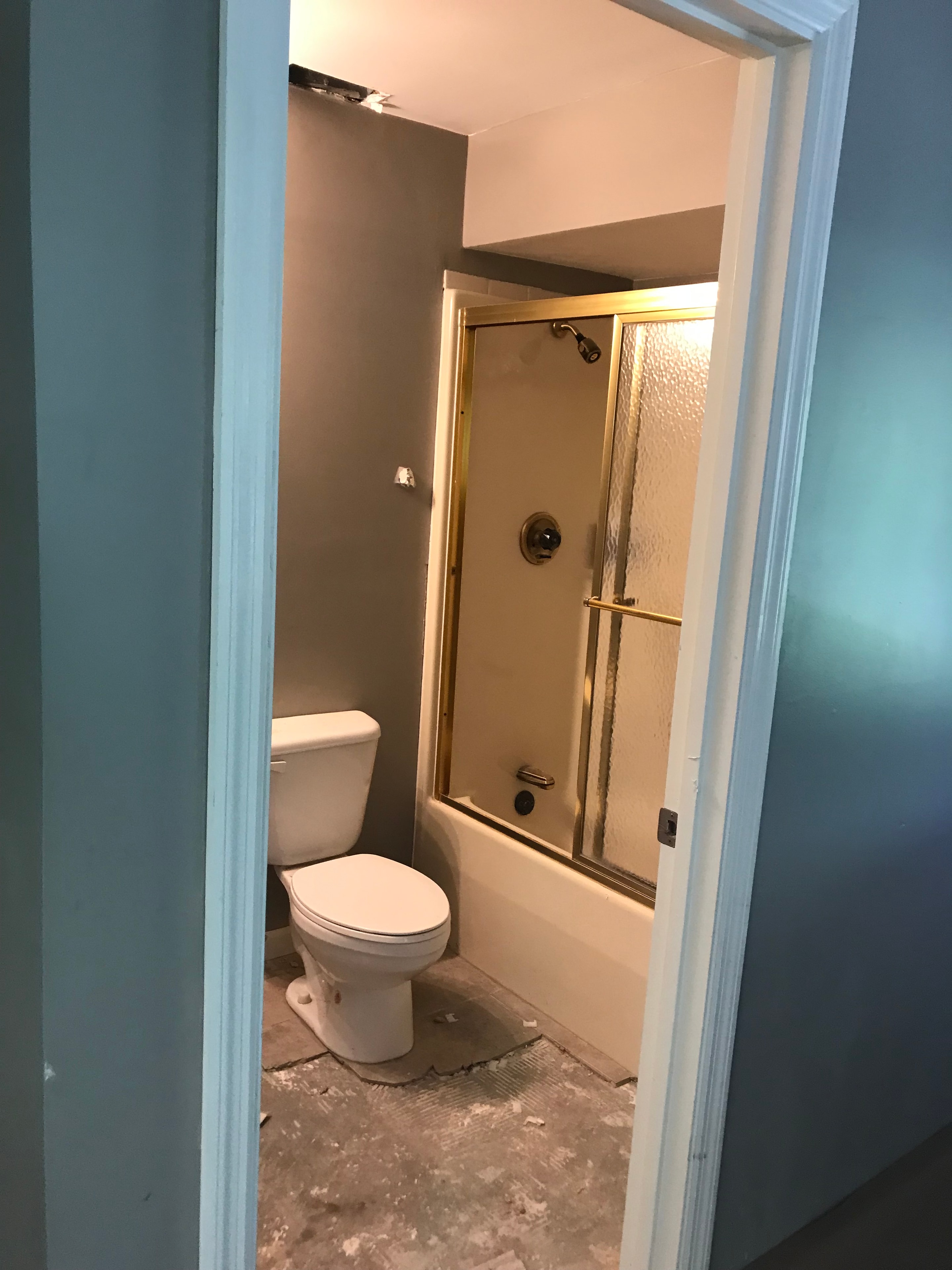 Bathroom before remodel — dated fixtures and flooring