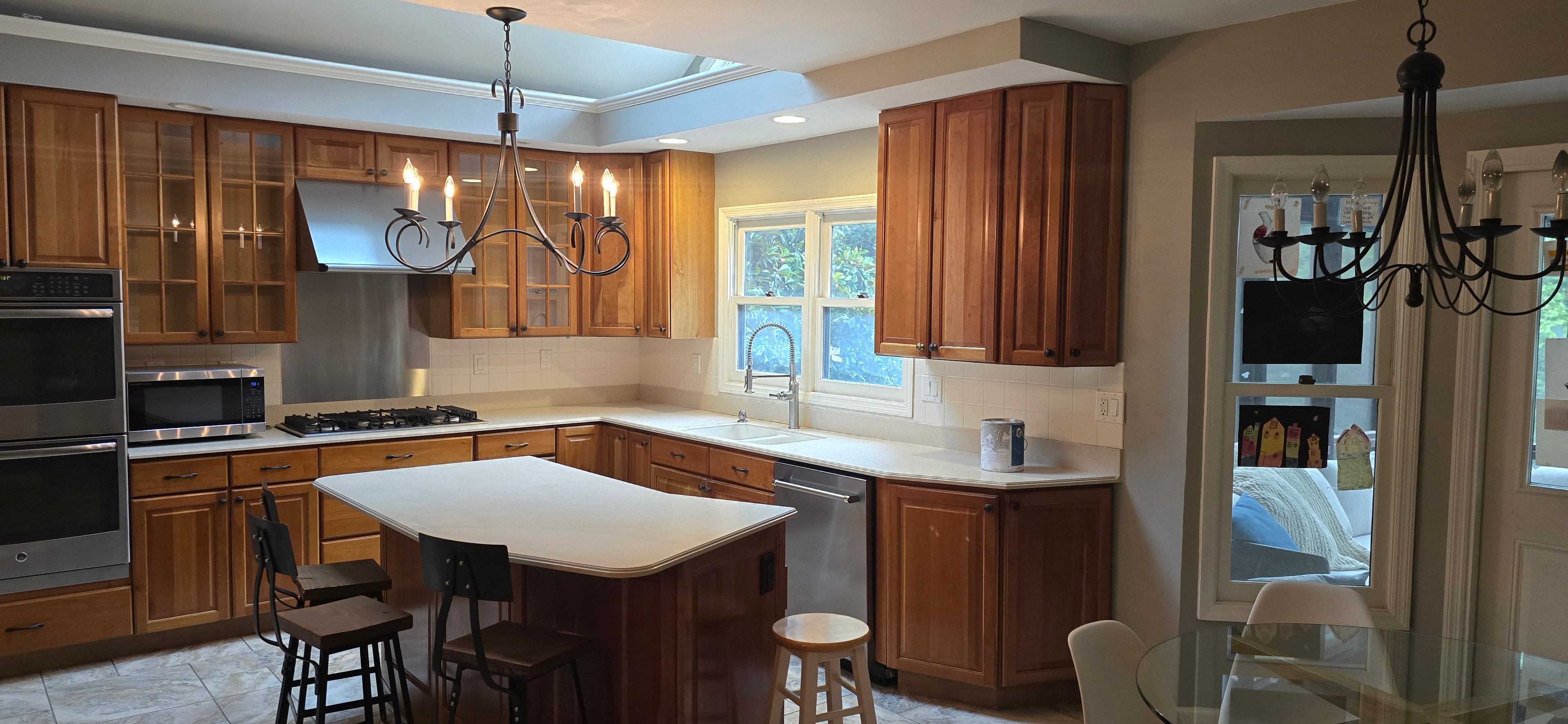 Kitchen before remodel — honey-oak cabinets, traditional fixtures